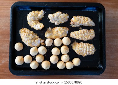 Frozen Breaded Chicken And Fried Small Potato Balls Before Cooking