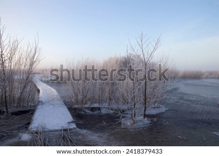 Frozen bridge in sunrise on a cold winter morning