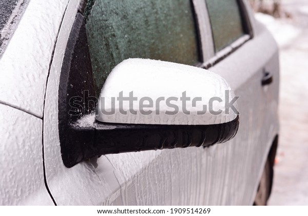A frozen car covered with ice. How to de-ice the frozen\
car, open a frozen shut car doors and avoid ice damage to car\
paint. 