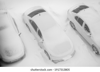 
A frozen car covered with snow in a parking lot. Winter - Shutterstock ID 1917313805