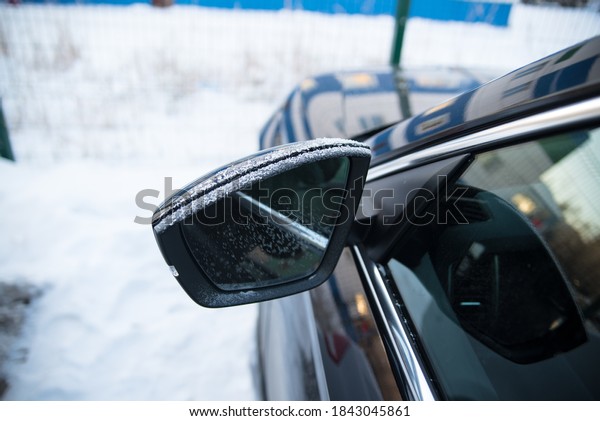 Frozen car, frozen mirror and side window, side view,\
winter, snow, ice