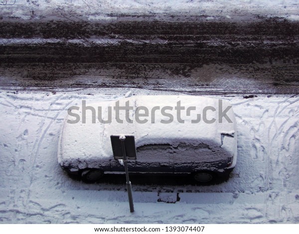  frozen car on a snowy parking lot                      \
       