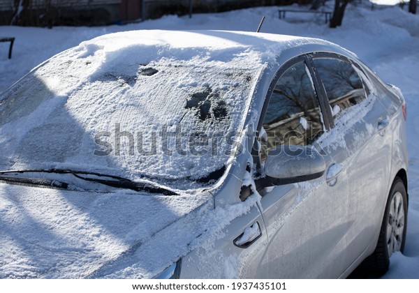 frozen car on the street of the city in winter.\
High quality photo