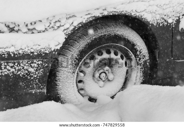 Frozen car wheel in\
winter