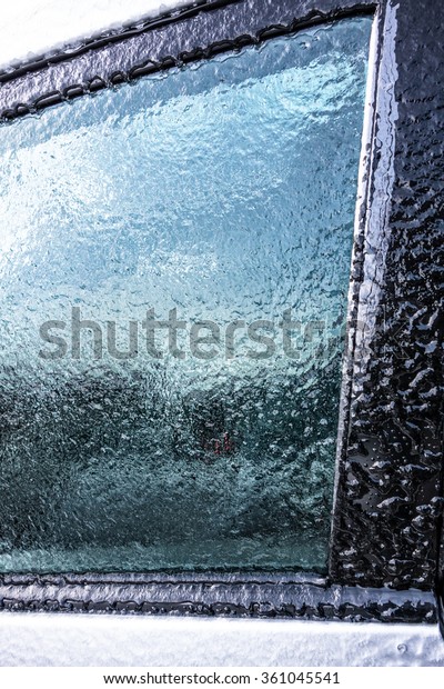 Frozen car window after a\
blizzard