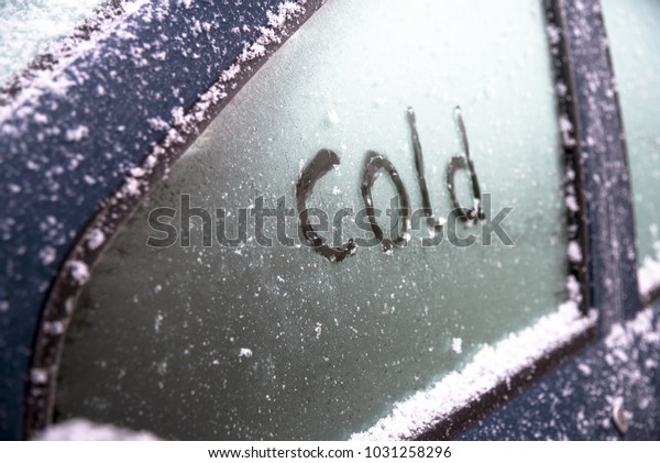 frozen\
car window with the hand written word cold, concept of safe driving\
in winter, selected focus, narrow depth of\
field