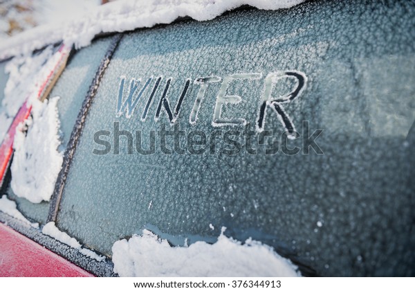 Frozen car window, car parked outside, winter\
transport issues