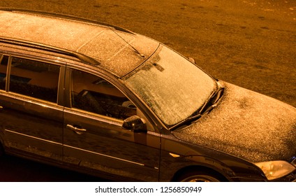 Frozen Car At Winter Night - Illuminated By A Street Lamp