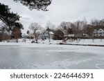 Frozen Charles River and riverside houses Natick MA USA