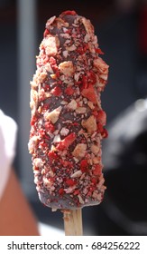 Frozen Chocolate Dipped Banana Pop Covered With Nuts And Dried Fruit Chips