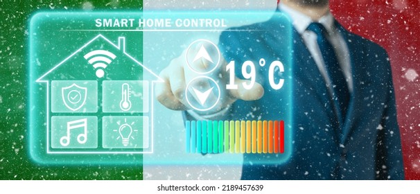 Frozen Citizen Of Italy Adjusting Heating Temperature On A Virtual Screen Of Smart Home Controller, Winter Blizzard Background. Concept Of Forced Thrift Because Increased Price For Heating Home.