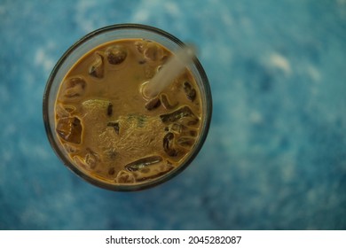 Frozen Coffee In Glass On Blue Background. Top View