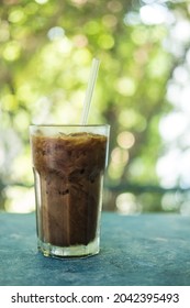 Frozen Coffee Mocha In Glass Against Nature Background.