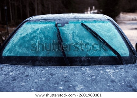 Frozen Covered with Ice Front Windshield Glass of a Car in Winter Outdoor Morning Low Temperature Conditions - Close Up