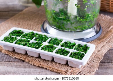 Frozen Cubes Of Herbs On A Wooden Table