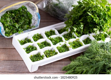 Frozen Dill Cubes In Molds For Ice Cubes On A Wooden Table