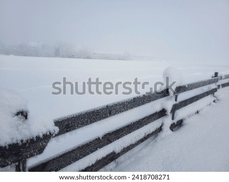 Frozen fence in deep snow