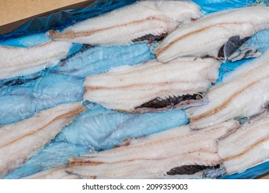 Frozen Fish Longtail Hake In A Box. Packaging With Interleave Plastic Film And Fish. Argentine Tradel Fish After Primary Processing Is Ready For Sale. Close-up