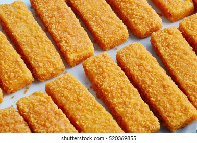 Frozen Fish Sticks In Tray For Oven On Wooden Background.
Convenience Food.