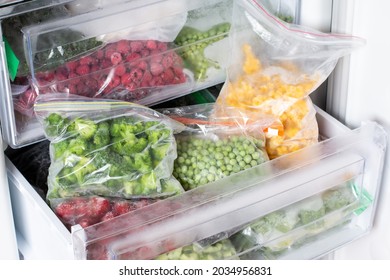 Frozen Food In The Freezer. Frozen Vegetables, Ready Meals In The Freezer. Frozen Meat, Food And Vegetables. Food Storage