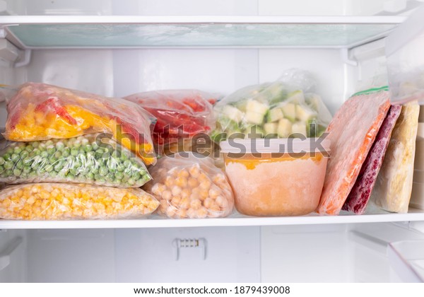 Frozen food\
in the freezer. Frozen vegetables, soup, ready meals in the\
freezer. Frozen meat, food, and vegetables \
