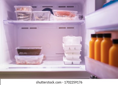 Frozen Food In Refrigerator. Meat, Seafood, Juice And Ice On Freezer Shelves. Stocks Of Meal.