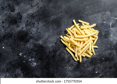 Frozen French fries, organic vegetables. Black background. Top view. Copy space