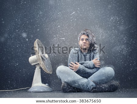 Frozen girl beside  a powerful fan , fan causing snow