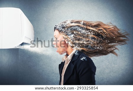 Frozen girl under a powerful air conditioner