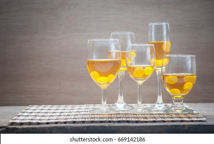 Frozen Grapes On White Wine In Glass Of Five With Still Life On Bamboo Mat Background, Golden Champagne, Copy Space