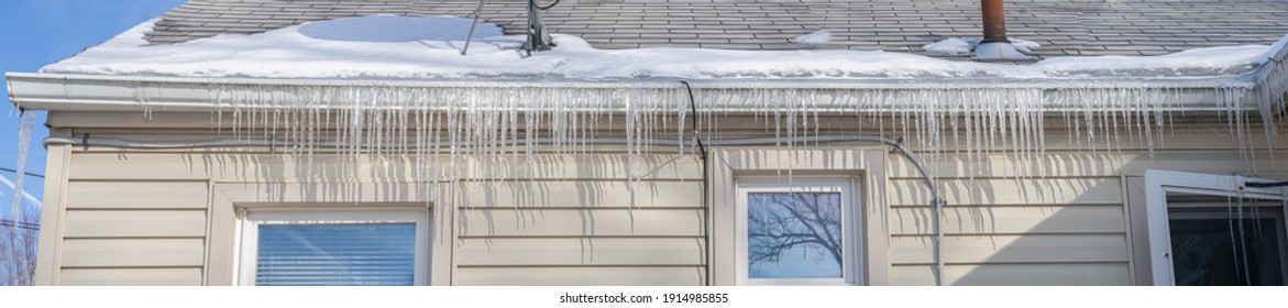 Frozen Gutters With Long Icicles Hanging From Ice Dams Panorama