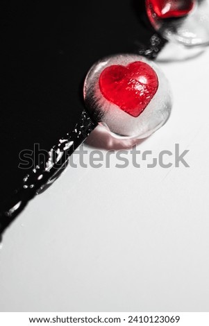 Frozen heart. Iced cold heart on white background. Red heart in ice.