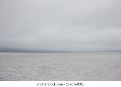 Frozen Ice Snow Covered Winter Lake With Endless Horizon