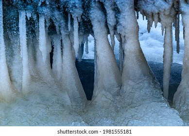 Frozen Ice Spikes In A River Under Bridge