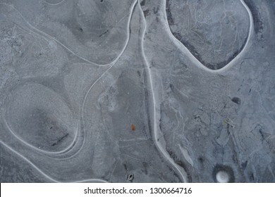 Frozen ice surface with beautiful pattern. Ice surfaces in the forest with abstract pattern