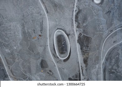 Frozen ice surface with beautiful pattern. Ice surfaces in the forest with abstract pattern