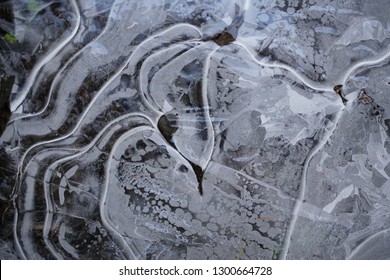 Frozen ice surface with beautiful pattern. Ice surfaces in the forest with abstract pattern