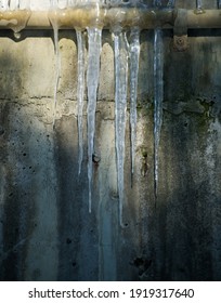 Frozen Icicles In Cold Winter On Concrete Grungy Wall Vertical Format Textured Background Space For Type
