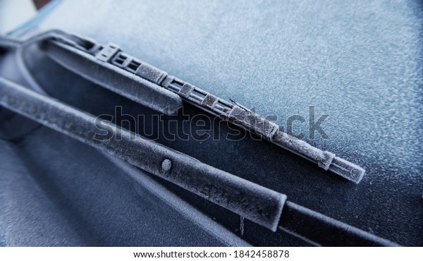 A frozen icy cold textured car in winter on a freezing\
morning, frozen windscreen. frozen solid in the windy freeze\
environment. frosty windows and black ice on the road.             \
           
