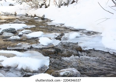 Frozen Icy River With A Snow Bank