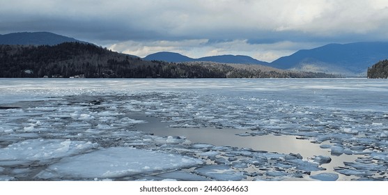 Frozen Icy Waters with Clouds and Mountains - Powered by Shutterstock