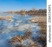 frozen lake. famous place. river in ice. reeds on the bank in ice. beautiful ice on the lake. winter natural landscape.