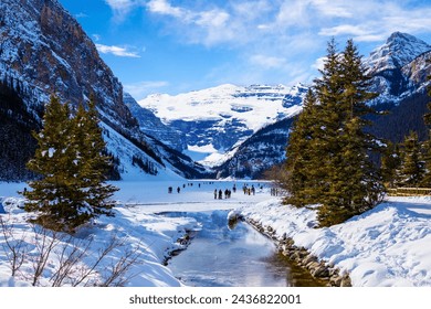 Frozen Lake Louise in the winter against the backdrop of the stunning Victoria Glacier. The iconic Lake Louise typically freezes from November to mid-April and draws visitors from all over the world. - Powered by Shutterstock