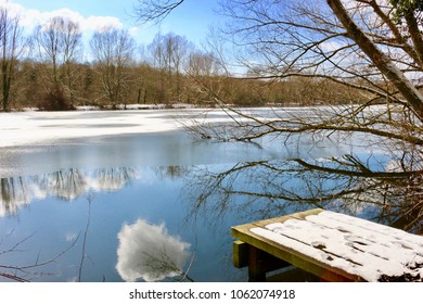 Frozen lake with reflected clouds