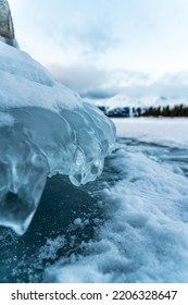 Frozen Lake Scene In Yukon Territory During Winter Season With Large Ice Built Up On Shoreline. 