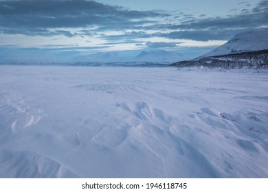 The Frozen Lake Torneträsk In Swedish Lapland. Beautiful Ice Forms Create An Amazing Sight.