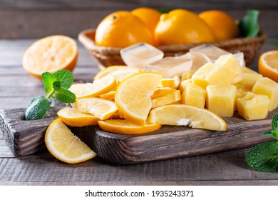 Frozen Lemon Slices And Cubes Of Lemon Juice On A Cutting Board On A Table