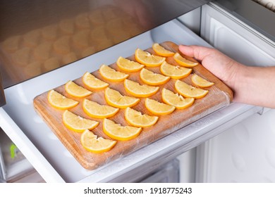 Frozen Lemon Slices On A Cutting Board In The Freezer