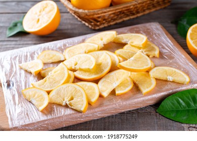 Frozen Lemon Slices On A Cutting Board On A Table