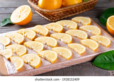 Frozen Lemon Slices On A Cutting Board On A Table